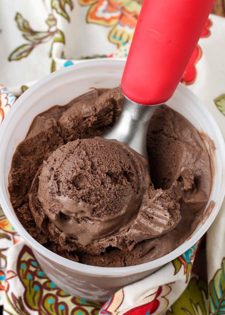 close up photo of ice cream in container with ice cream scoop