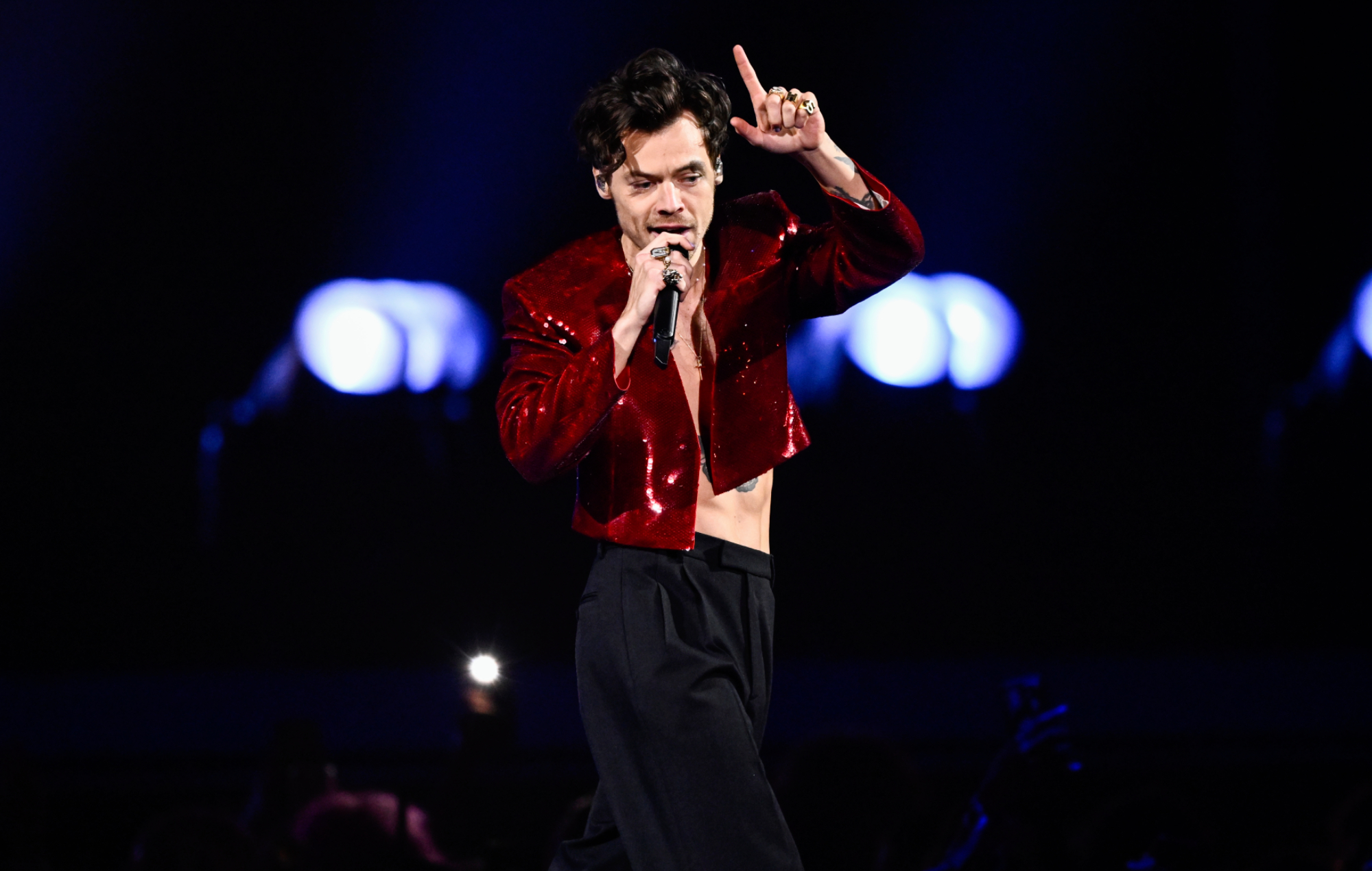 Harry Styles performing live on stage, photo by Gareth Cattermole/Getty