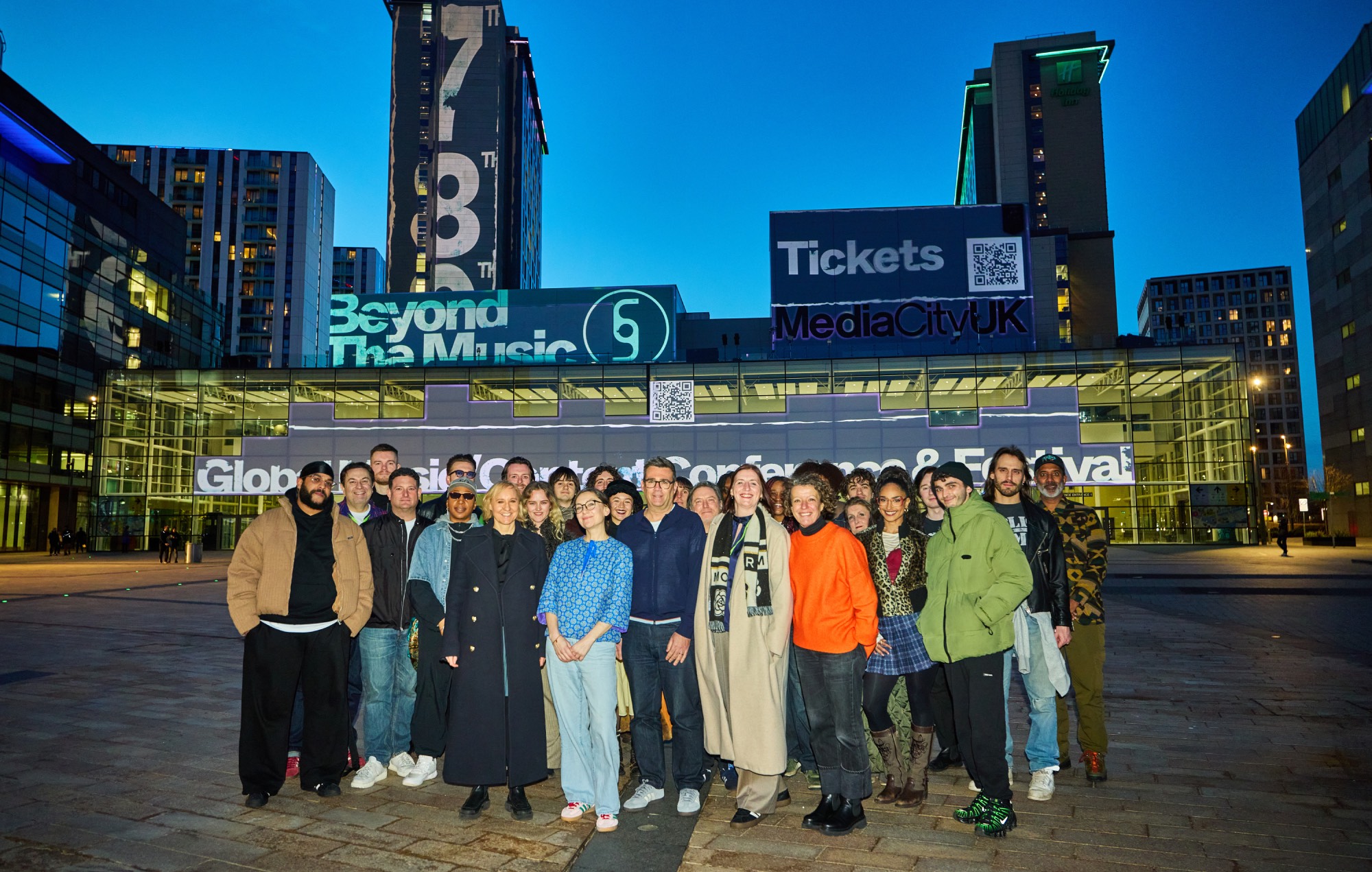 Front L-R: Sarah Pearson, Sally Cook, Andy Burnham, Rose Marley, Alice Webb and Manchester musicians celebrate the launch of Beyond The Music at MediaCity