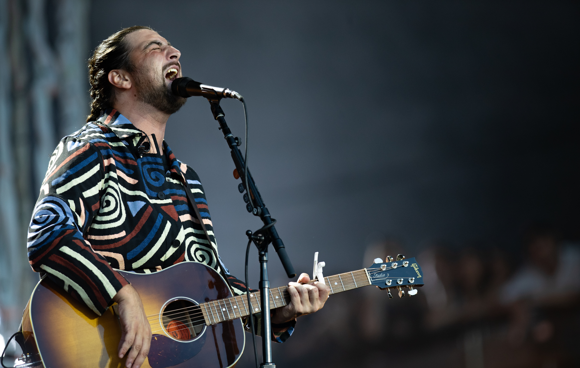 Noah Kahan performing live on stage, photo by Shane Anthony Sinclair/Getty