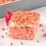 A slice of pink cake on a plate.