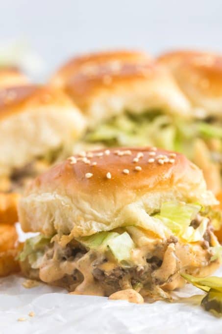 All the fixings and a special sauce on a beef slider.