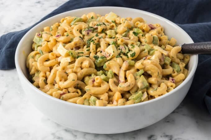 A bowl of Chick-fil-A Macaroni Salad with a blue napkin