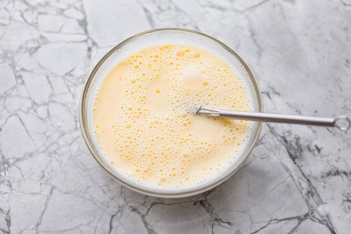 Bowl of milk and egg whisked together.