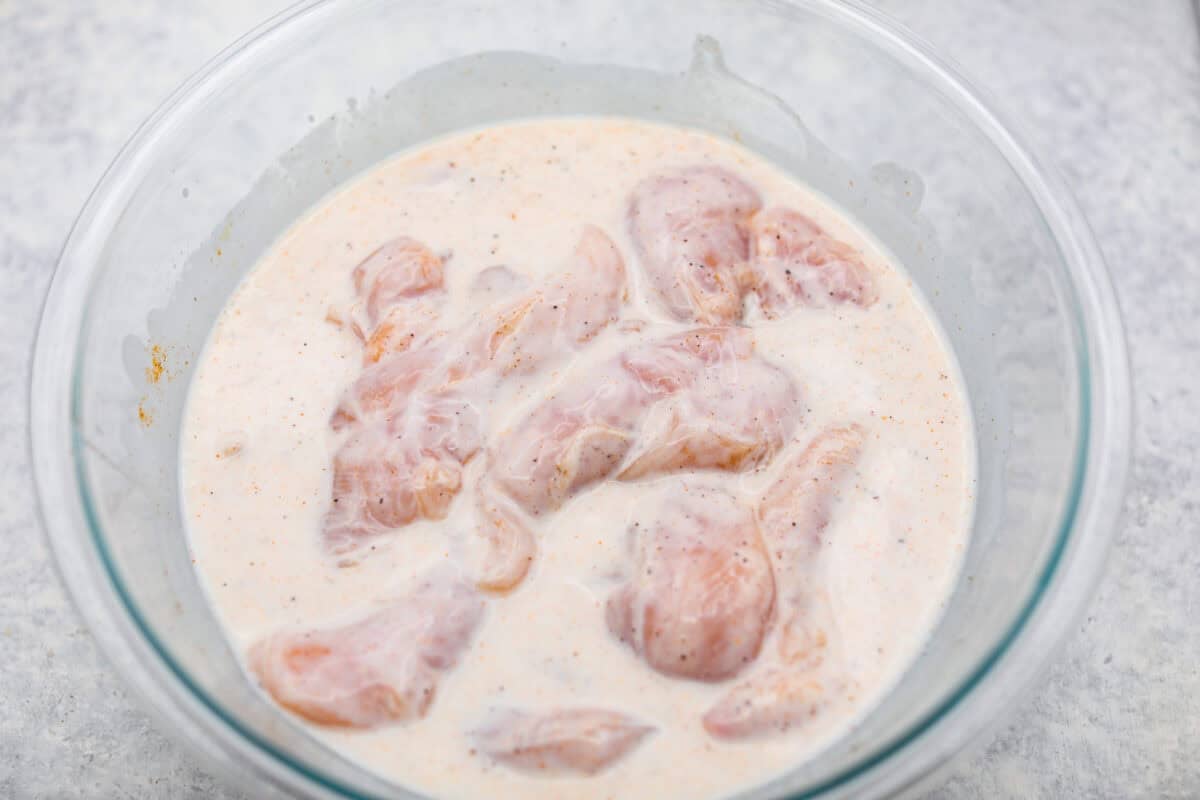 Marinade ingredients and chicken all mixed together. 