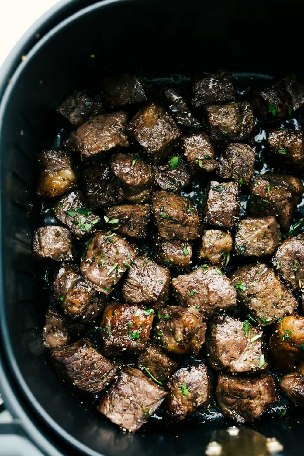 Cooking dinner can feel expensive fast, so I put together a “Splurge or Save” menu that lets you build the perfect meal without the stress of budget A close up of garlic steak bites in the air fryer.