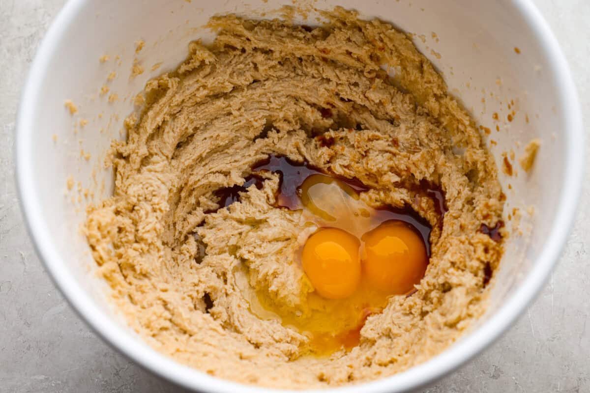 Bowl of beaten sugar and butter with eggs and vanilla added to it. 