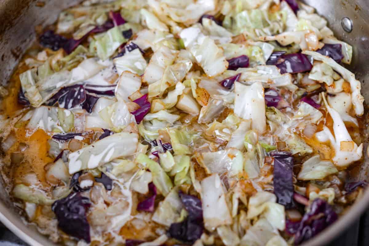 Cabbage, chicken broth, cream, and whiskey added to the skillet. 