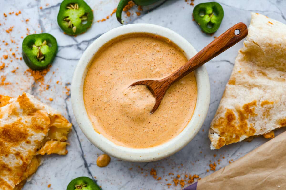 Small bowl filled with Taco Bell quesadilla sauce. 