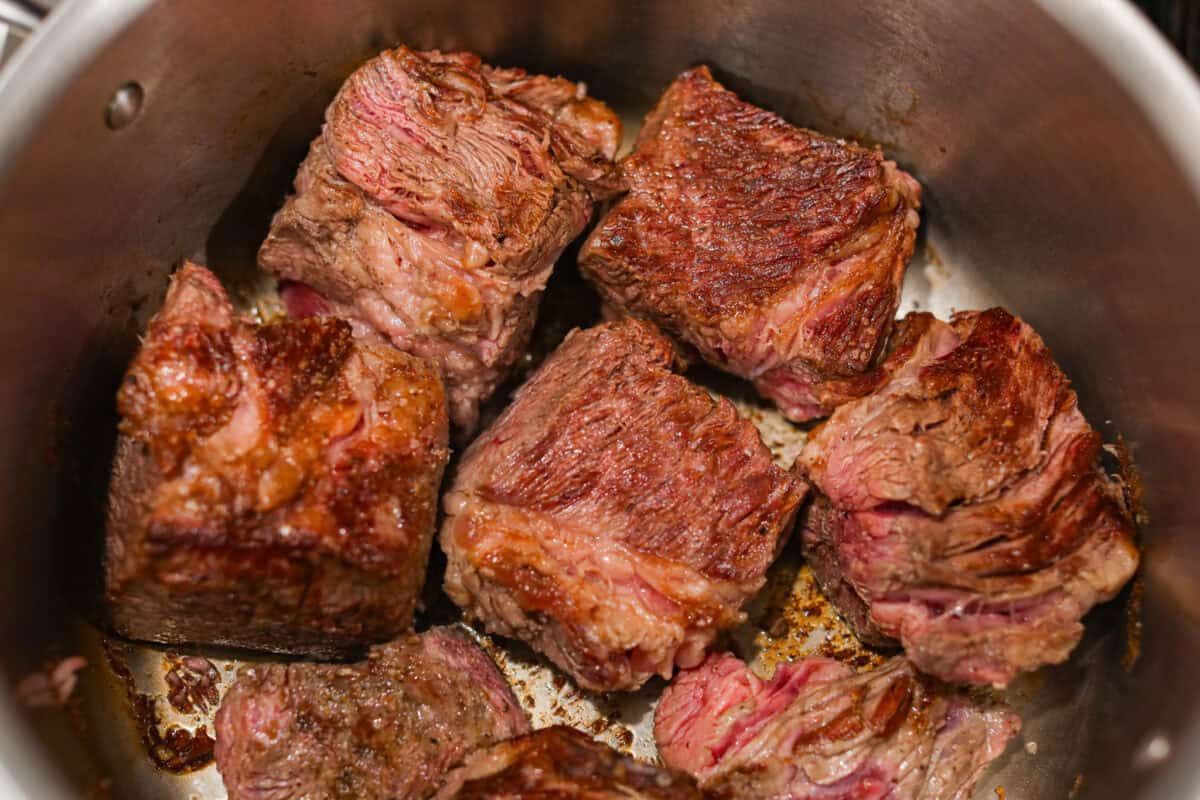 Beef browning in a pot. 
