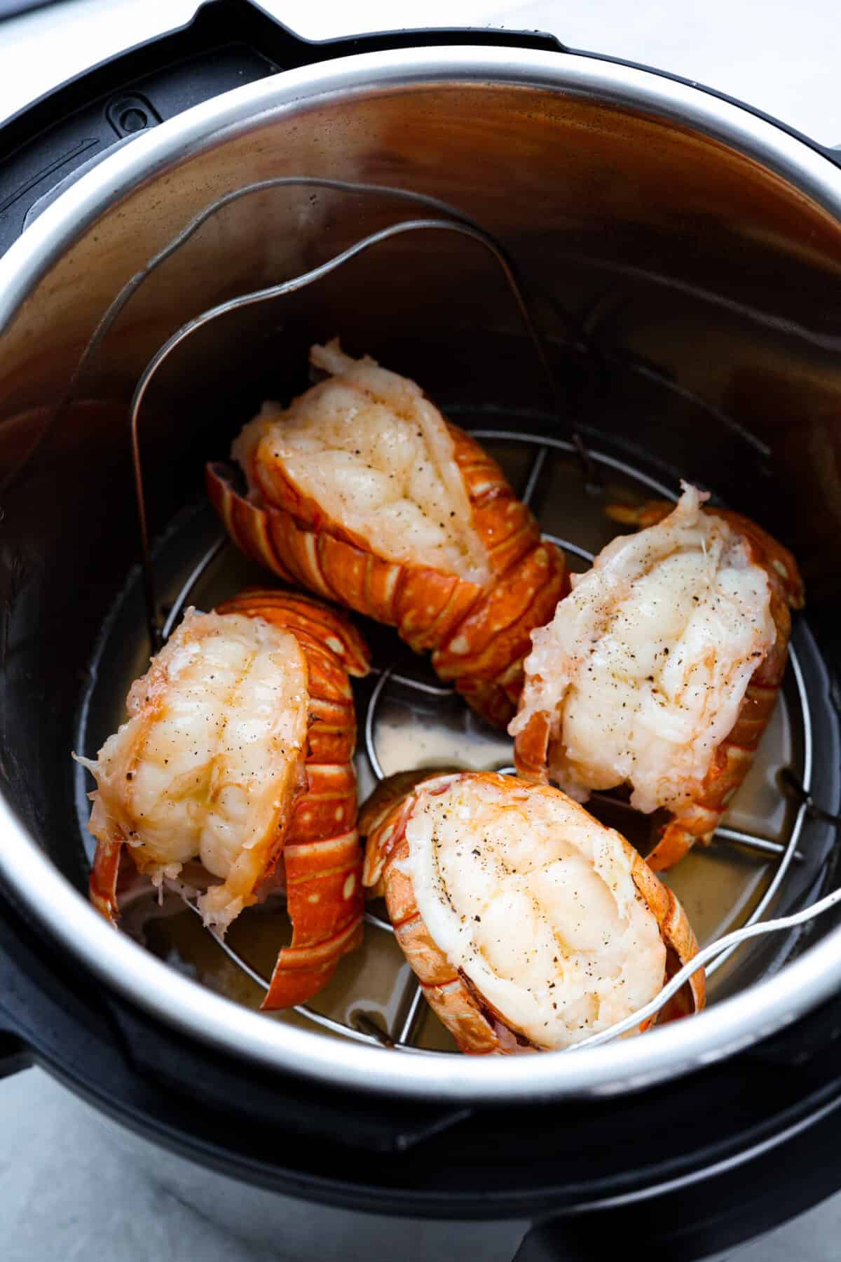 Overhead shot of instant pot lobster tails inside the instant pot.