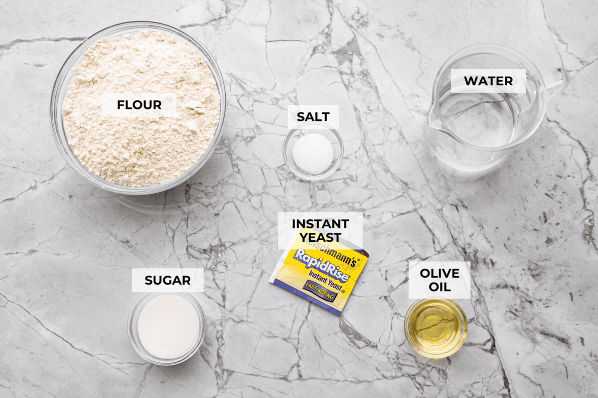 Overhead shot of labeled slow cooker bread ingredients. 