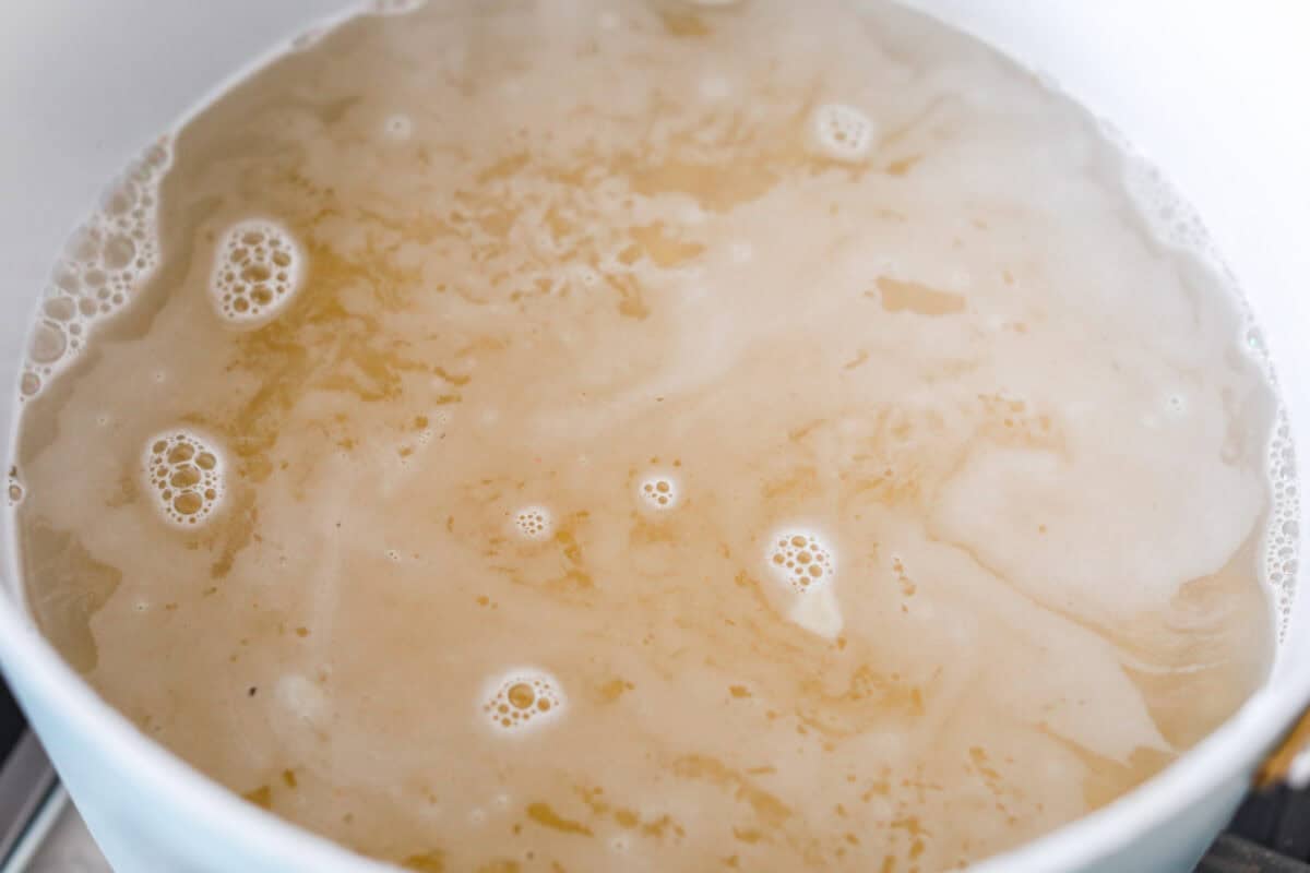Spaghetti noodles cooking in boiling water.
