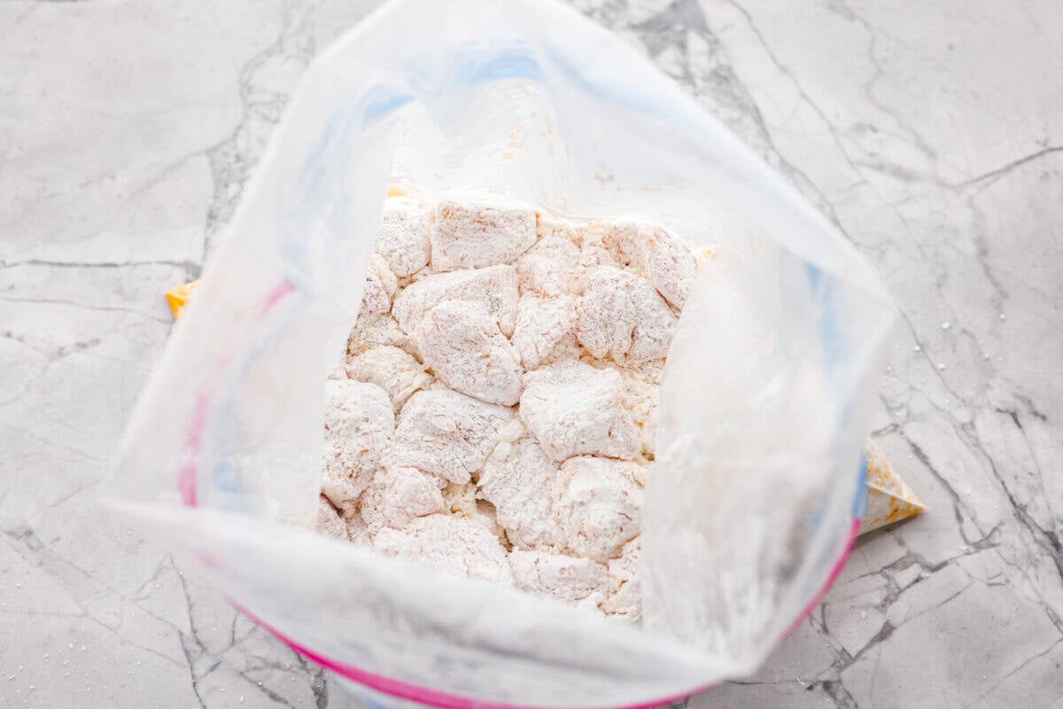 Bag of seasoned chicken covered in corn starch. 