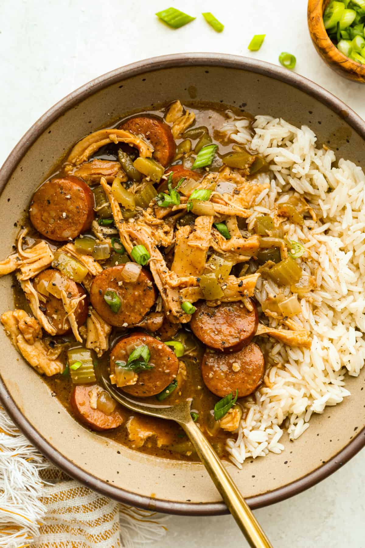 Bowl of chicken and sausage gumbo with white rice.