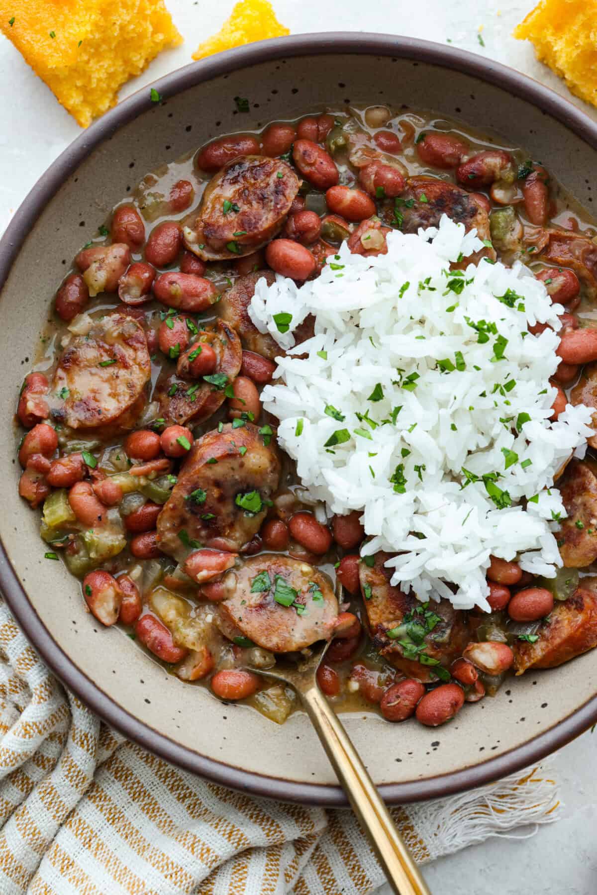 Bowl of red beans and rice with a scoop of rice on top. 