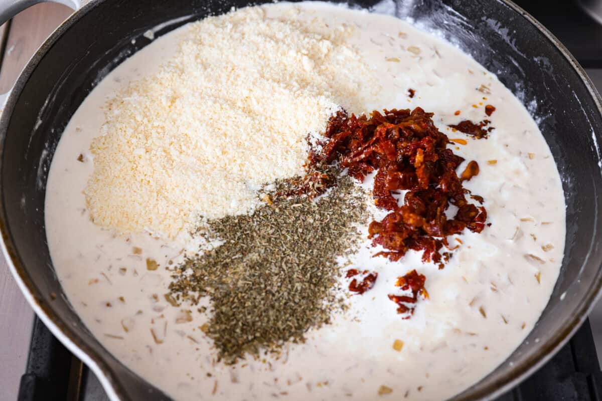 Parmesan, sun dried tomatoes, and seasonings added to the skillet. 
