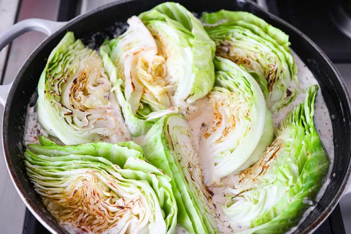 Cabbage wedges added back to the skillet. 