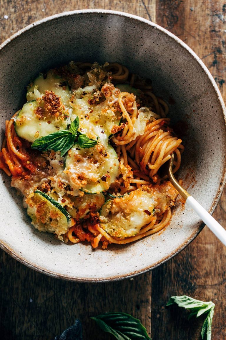 Spaghetti topped with cheesy crispy zucchini.