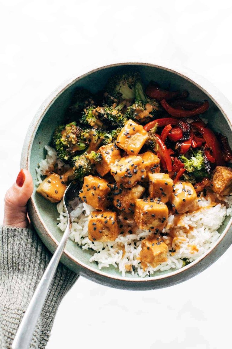 Peanut tofu in a bowl with peppers and broccoli.