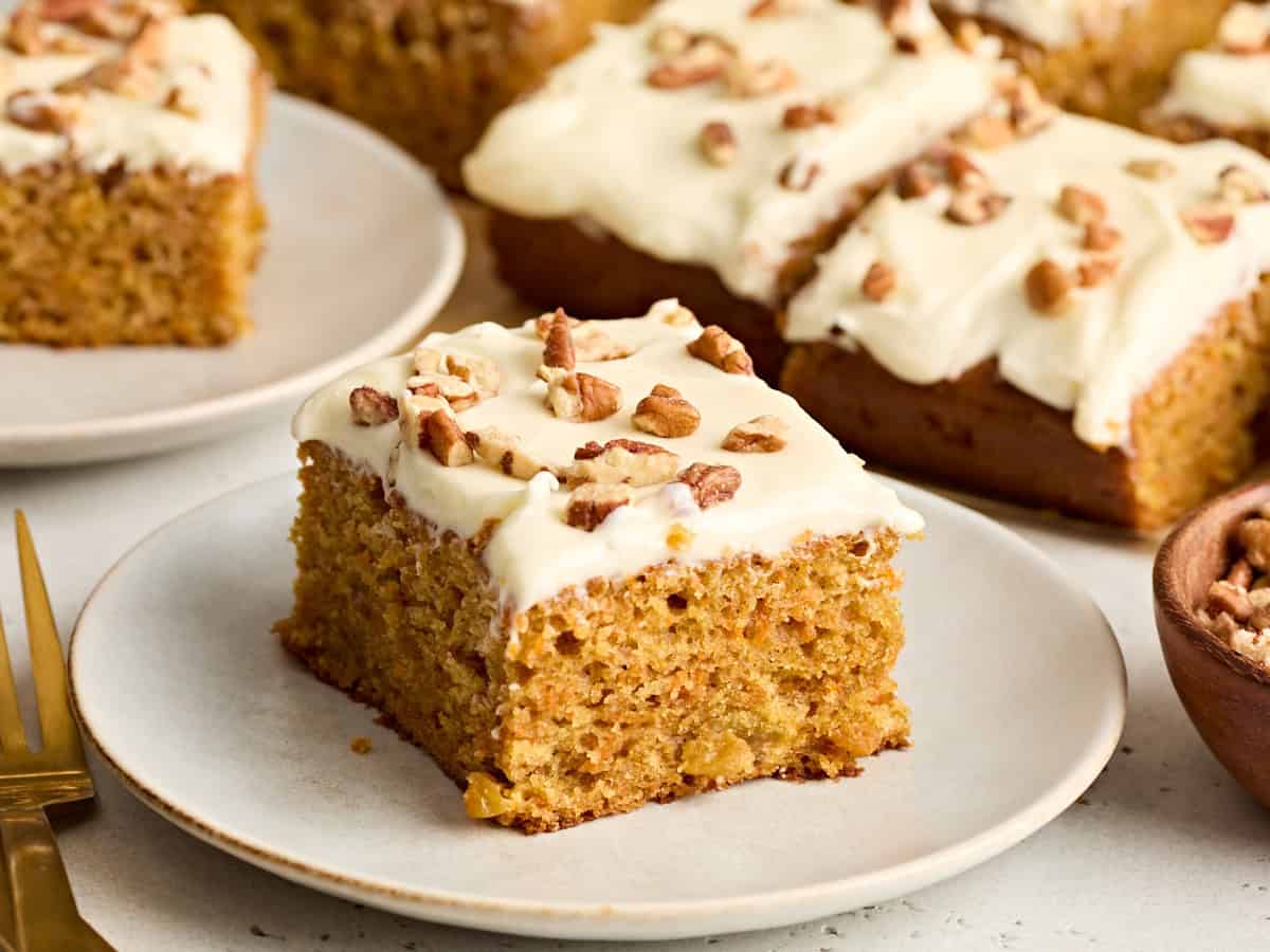 Side view of a slice of carrot cake on a plate