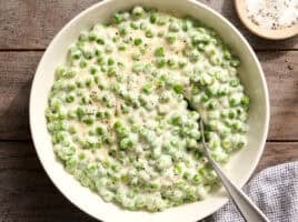 Overhead view of a bowl of homemade creamed peas.