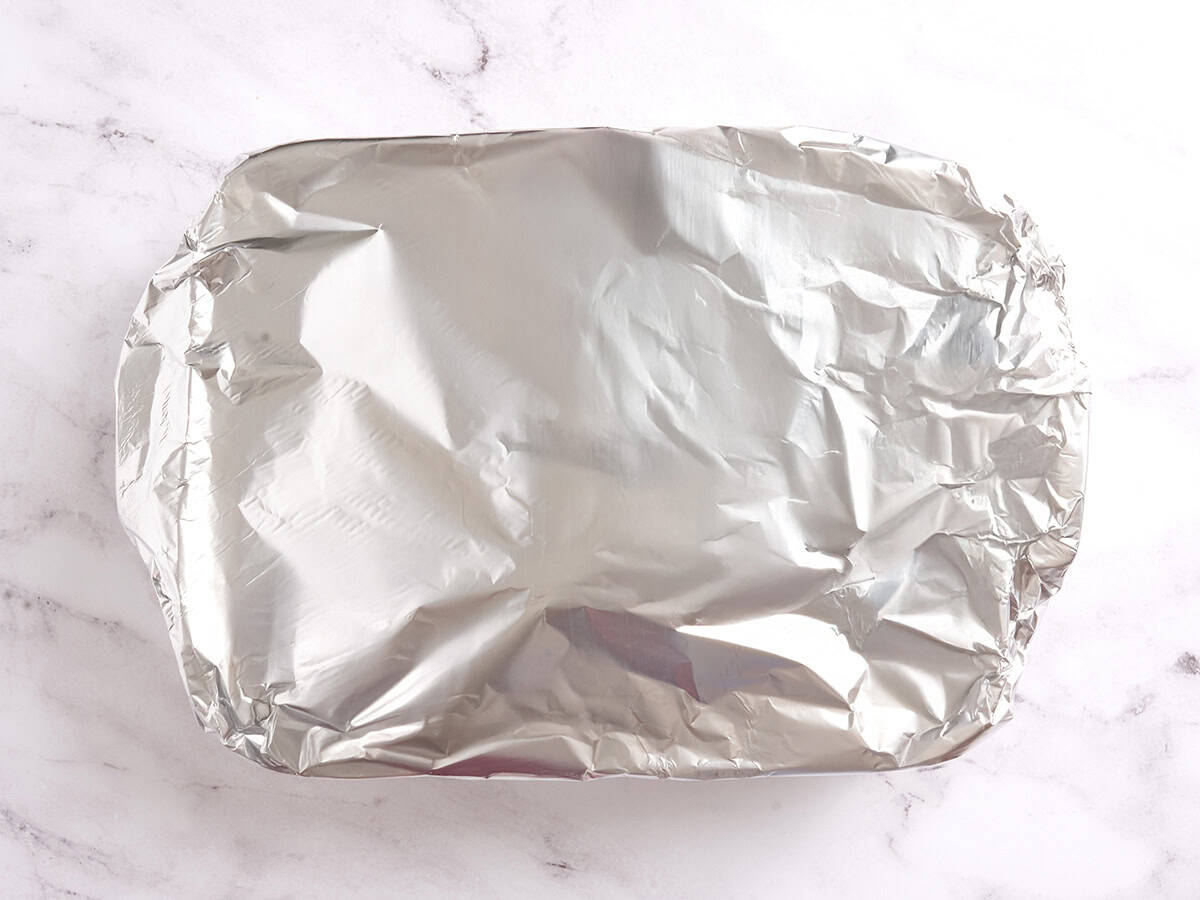A baking dish covered with foil.