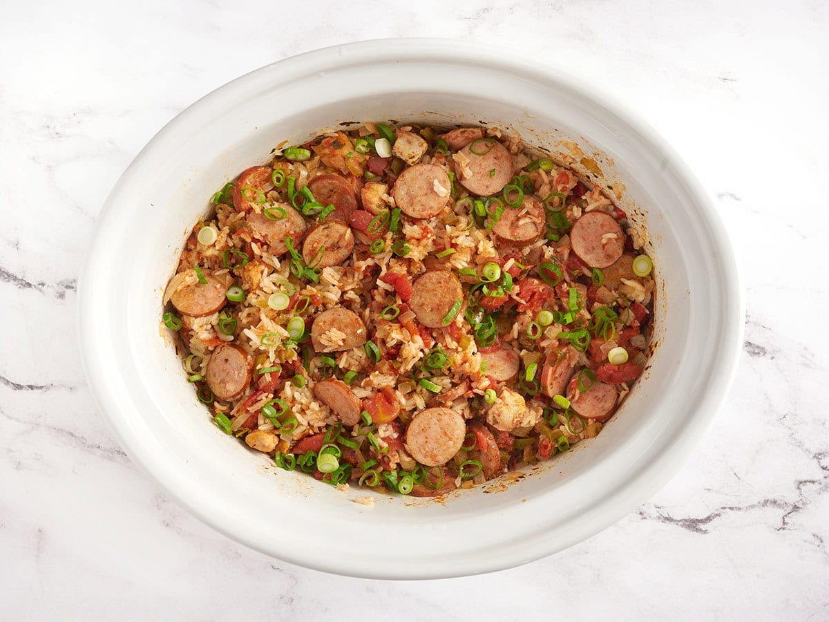 Slow cooker jambalaya in a white crockpot. 