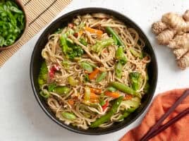 Overhead view of a bowl of teriyaki noodles and vegetables.