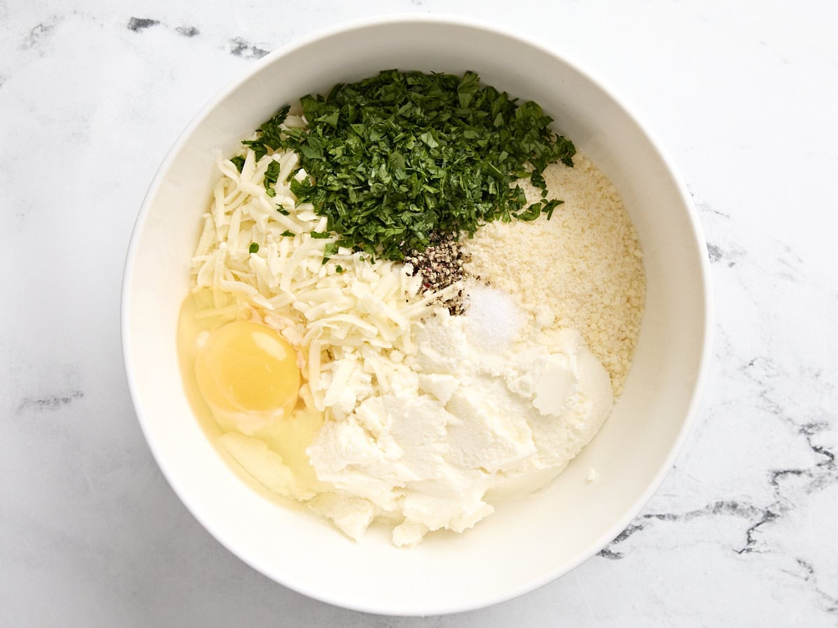 Stuffed shells cheese mixture ingredients in a bowl.