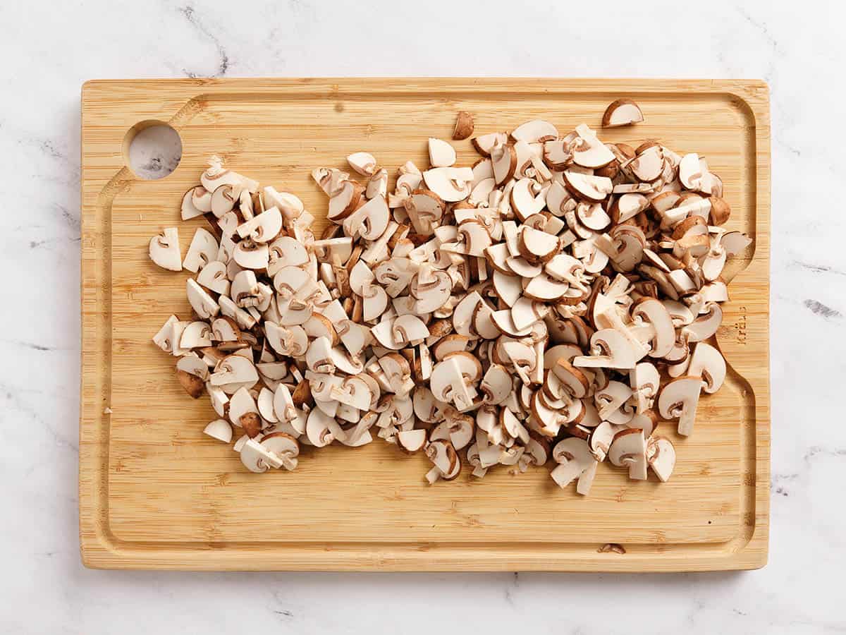 Diced mushrooms on a cutting board.