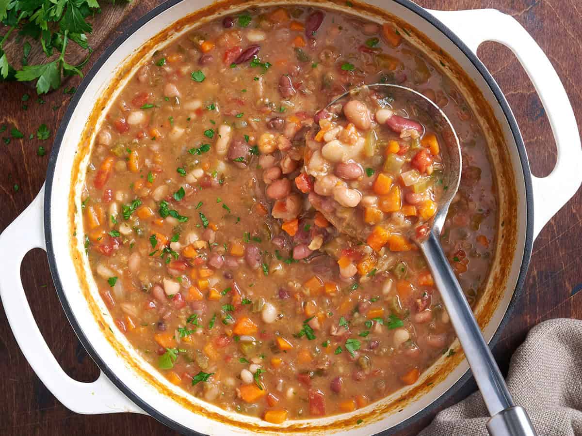 Overhead view of homemade 15 bean soup in a pot with a ladle.