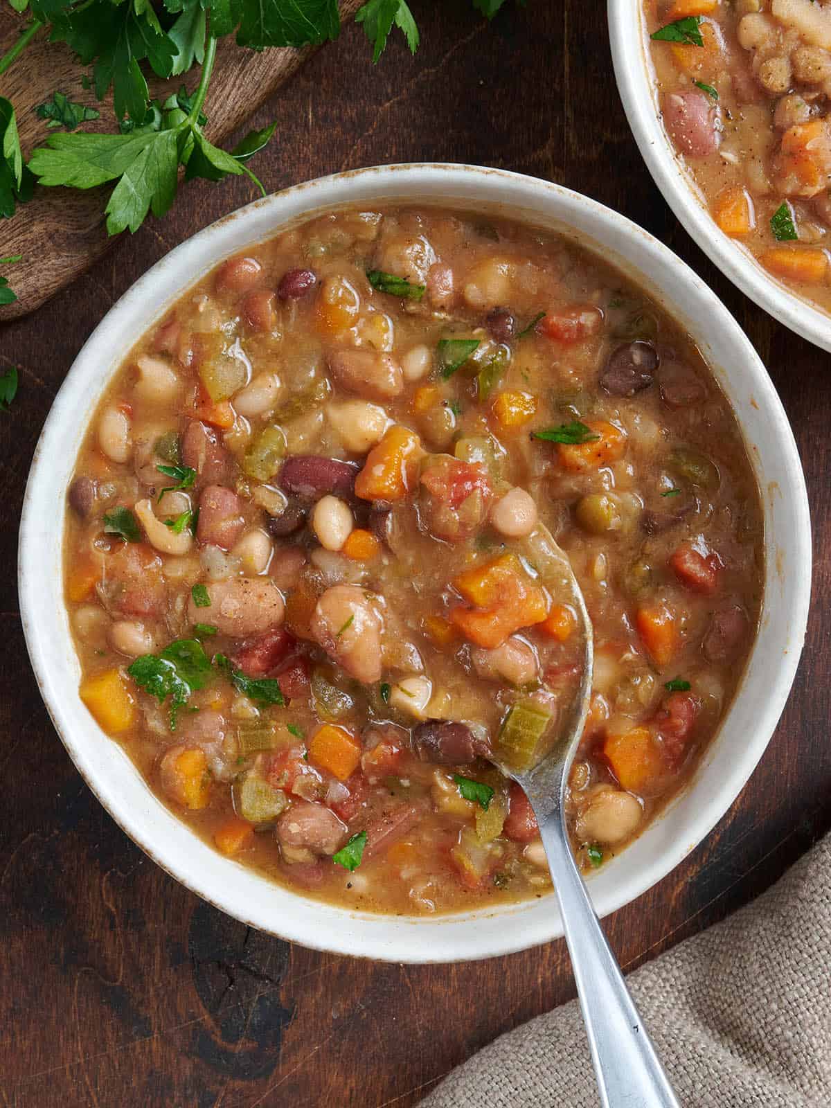 Overhead view of 15 bean soup in a bowl with a spoon.