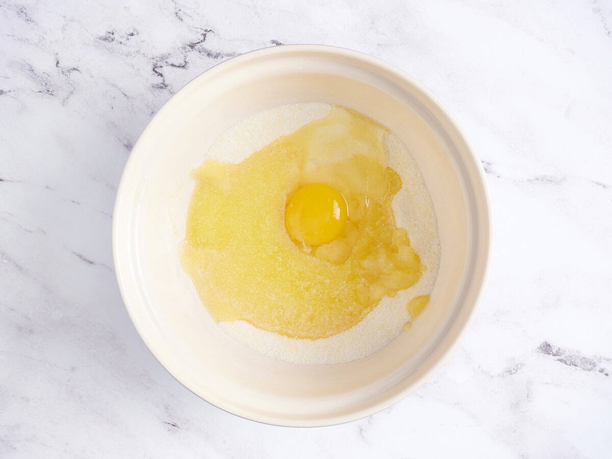 Egg and melted butter in a bowl.