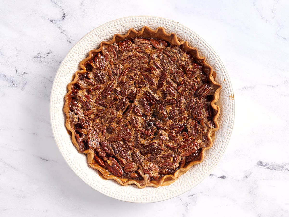 Cooked pecan pie in a pie dish.