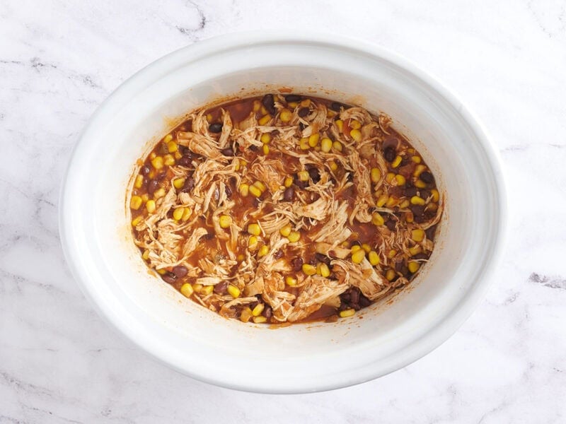 Slow cooker taco bowls in a white crockpot.