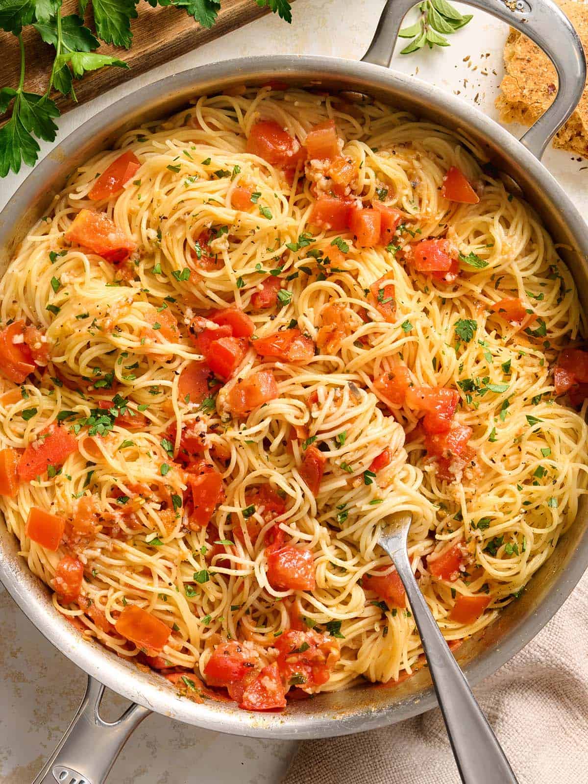 Overhead view of a pot of angel hair pasta pomodoro with a fork.