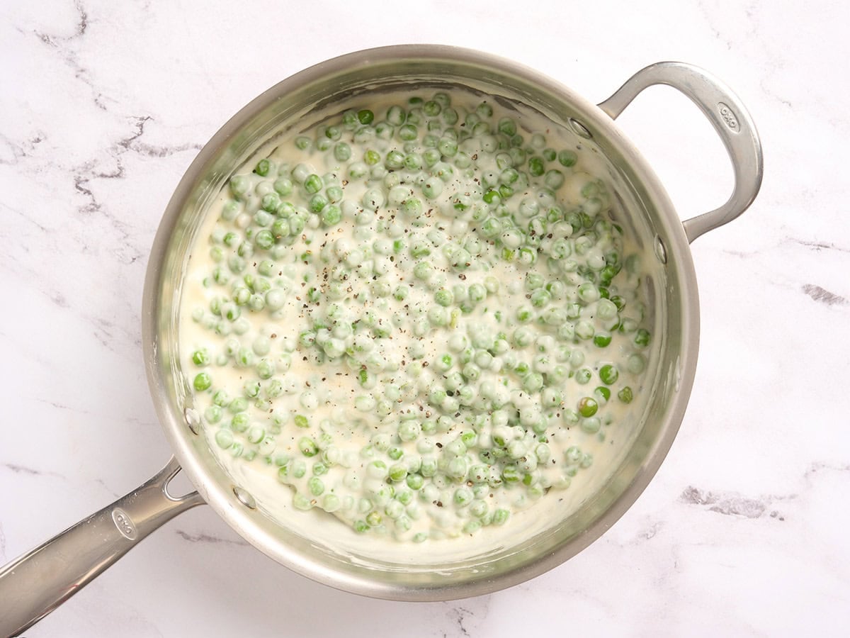 Creamed peas in a skillet.