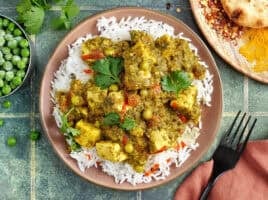 Overhead view of a vegan tofu curry on a plate with white rice.
