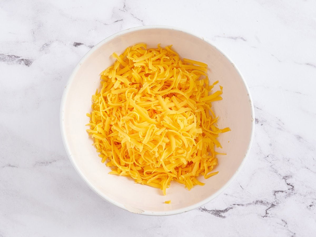 Shredded cheddar in a bowl.