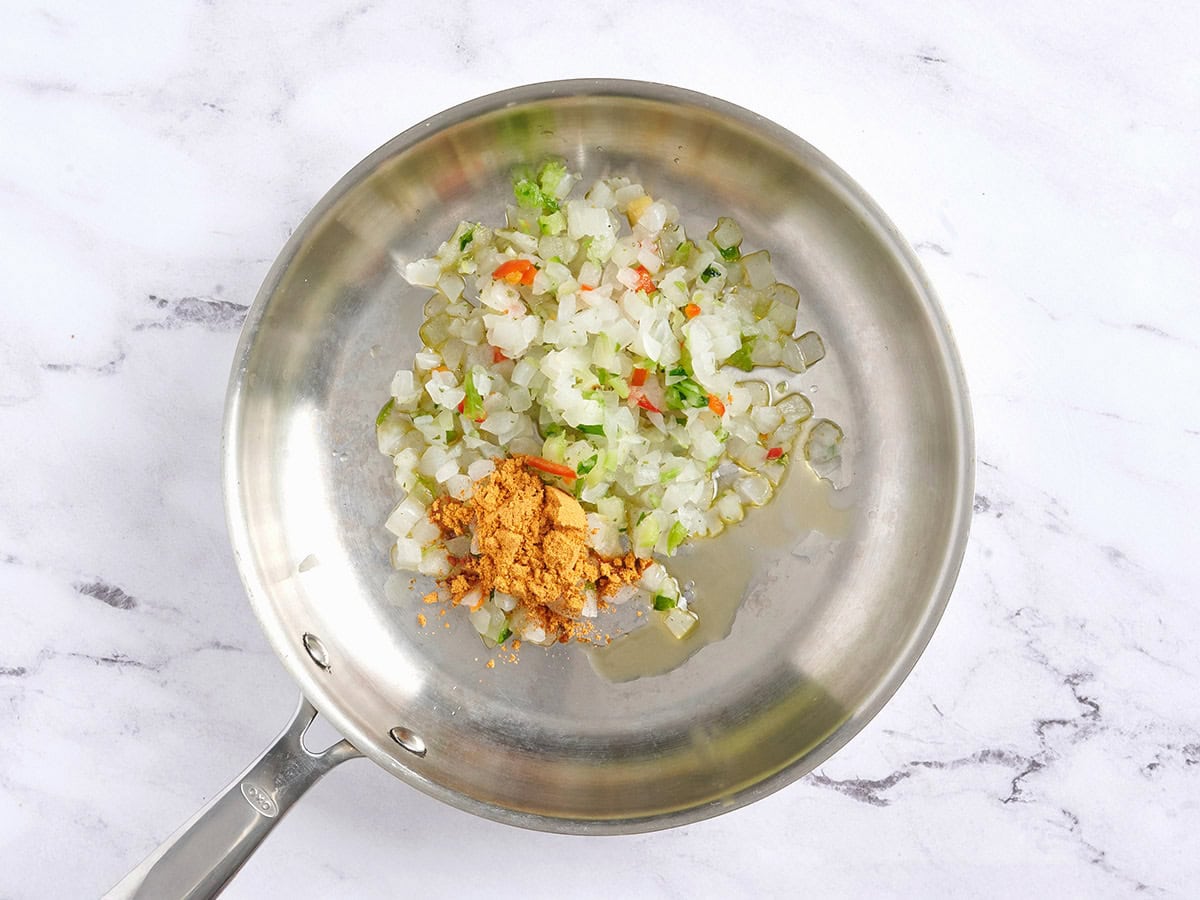 Frozen mixed veggies and taco seasoning in a skillet.