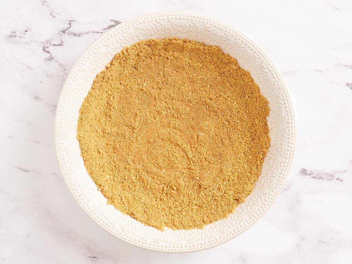 Graham cracker crust in a pie dish.