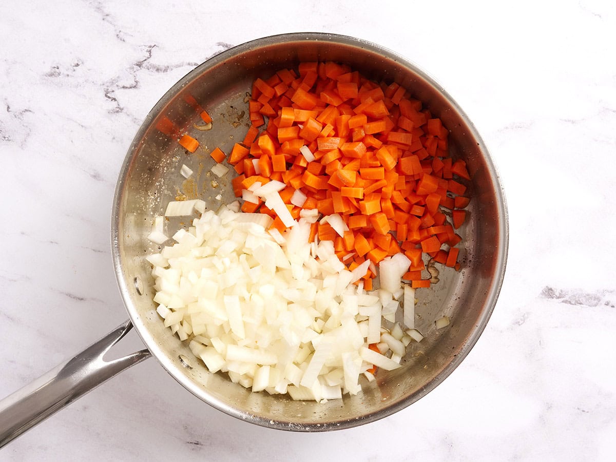 Diced onions and carrots in a saucepan