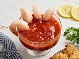Side view of seafood sauce in a bowl with shrimp.