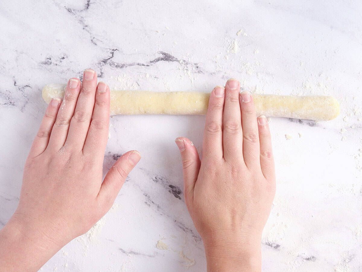 Rolling the dough into strings. 