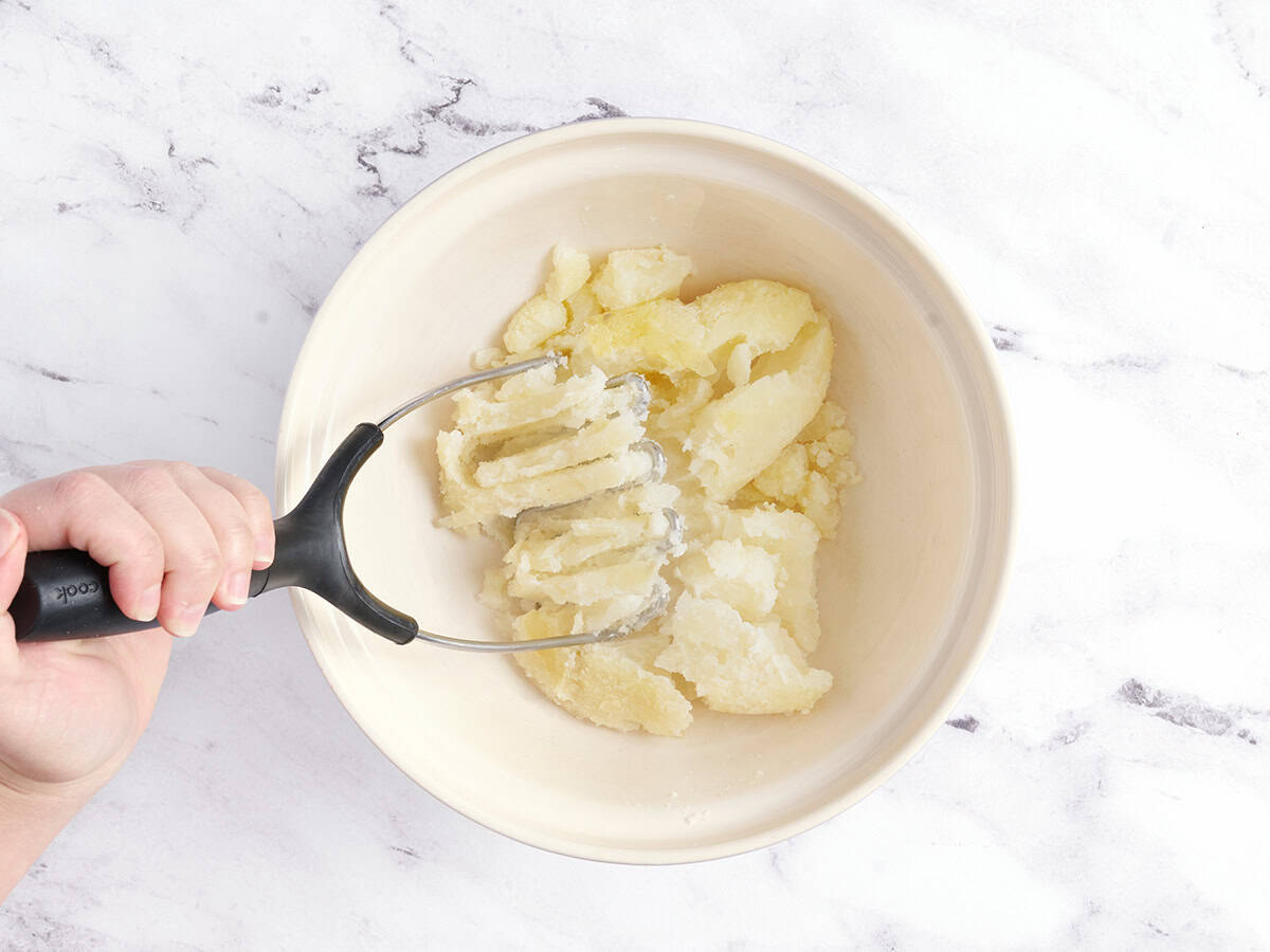 Mashing the potatoes. 