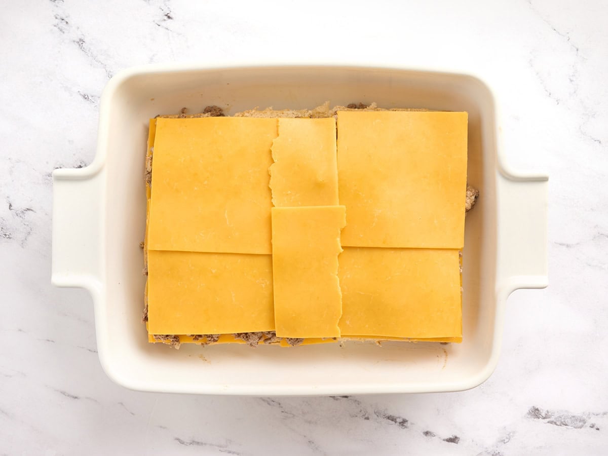 Another layer of cheese added to beef sliders.