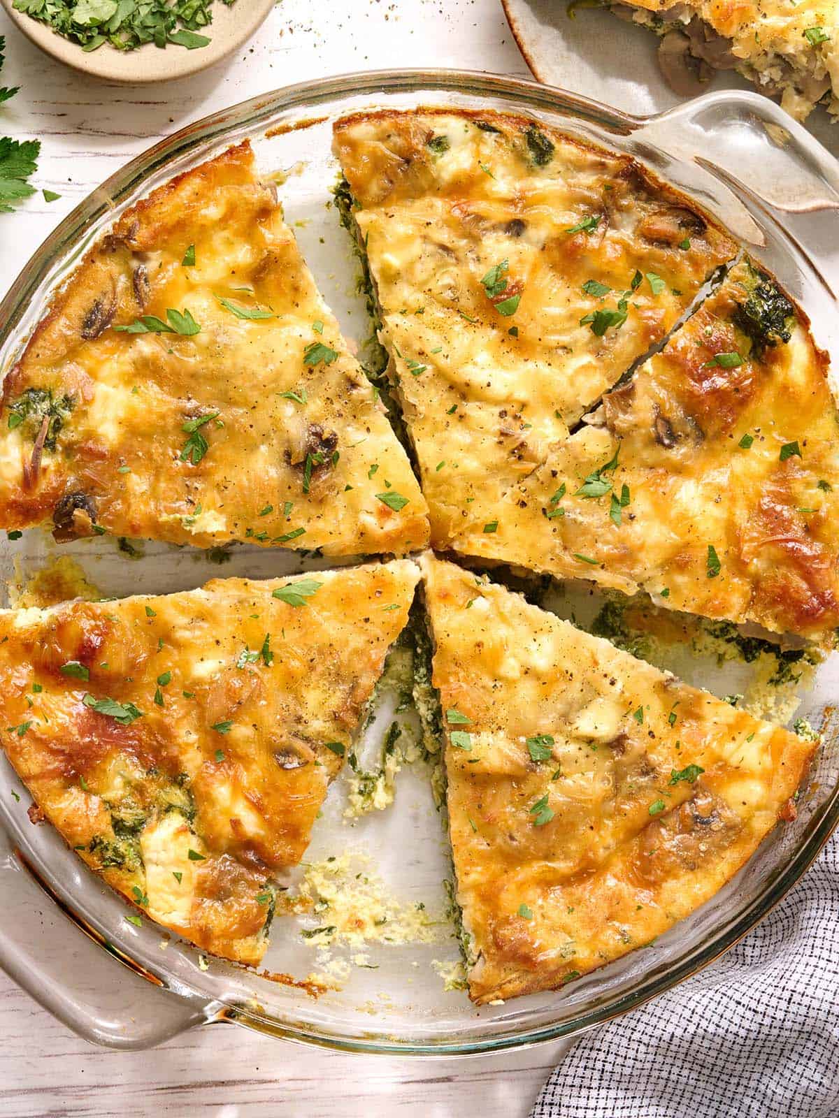 Overhead view of slices of crustless quiche in a dish.