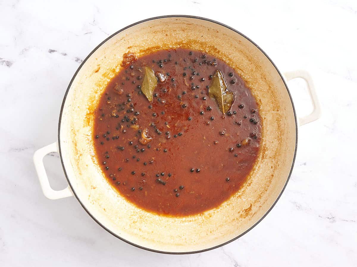 Chicken adobo marinade reduced in a pot.