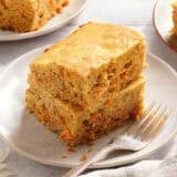 Side view of carrot cake bars on a plate.